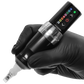 Spektra Flux wireless tattoo machine, held by a gloved hand